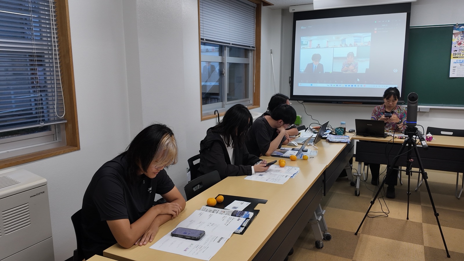 画面の試作をスマホで試す学生と張教授